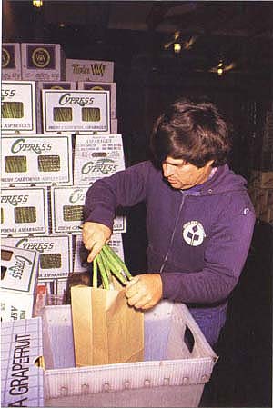 CDFA technician samples asparagus for pesticide residues. Most foods do not have large detectable residues; dietary hazards for the general population are low.