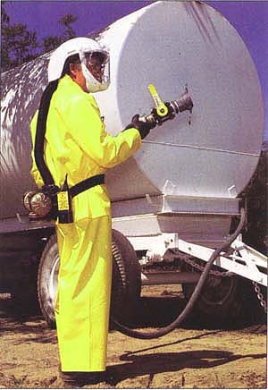 This pesticide applicator is outfitted with a respirator and protective clothing. Occupational exposures to pesticides are far greater than those from food consumption.