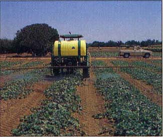 Tractor-mounted sprayer with nozzles designed for dispensing reduced droplet size under high pressure (400 – 450 psi).
