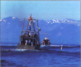 Charles Goldman shows Bill Clinton and Al Gore how to test water clarity during a 40-minute tour of Lake Tahoe in the UC Davis research vessel (shown at left).