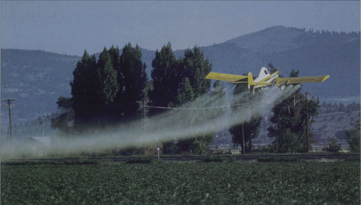 As subdivisions spring up around farmland, growers are forced to change their practices, such as curtailing aerial pesticide sprays.