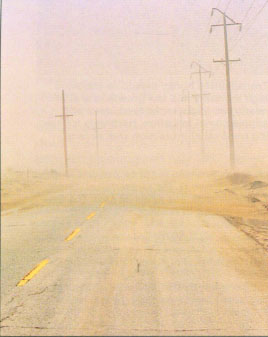Dust storms, like this one pictured along a county road in the Antelope Valley, have led to serious traffic accidents and violations of air quality standards.