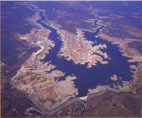 Photographs of Folsom Dam near Sacramento illustrate the variability of California's water supply: Water levels at the height of the 1976-1977 drought.