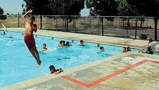 Exposure to lifelong activities such as swimming, at this public pool in Parlier, above, as well as dancing, aerobics and running, can help children develop healthy exercise habits.