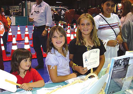 A group of foundations funded a civic engagement project to promote diverse participation in decision-making regarding how Proposition 10 funds are spent. Children visit the Yolo County commission's fair booth.