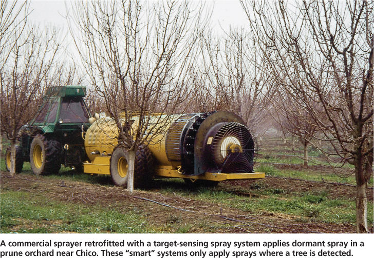 A commercial sprayer retrofitted with a target-sensing spray system applies dormant spray in a prune orchard near Chico. These “smart” systems only apply sprays where a tree is detected.