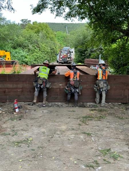 Construction crew and bridge retaining