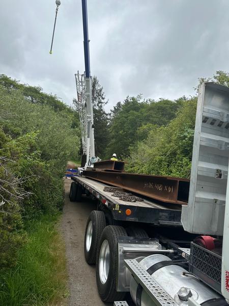 Truck bringing in bridge beams