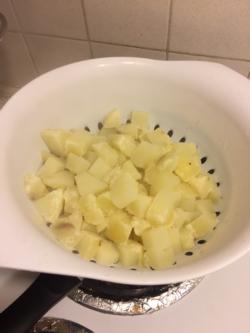 Drain cooked potatoes