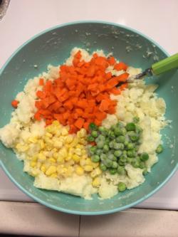 Mix in carrots, corn, and peas