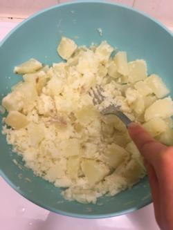 Mash potatoes with a fork.
