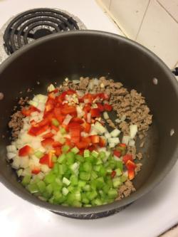 Add in onions, garlic, bell peppers, and celery. Cook until soft.