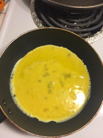 Pour eggs evenly into the pan.