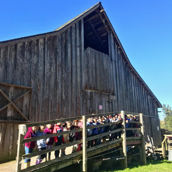 Students pose in front of one of our historic barns