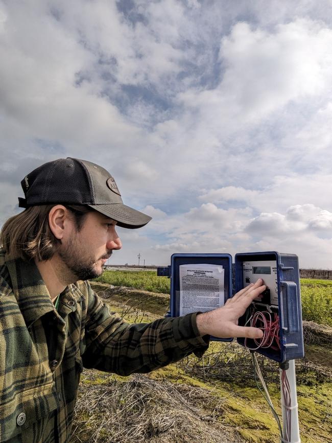 Luke Paloutzian, staff research associate, checking soil moisture sensors.
