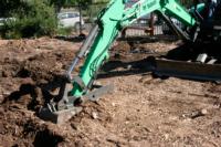 Excavator loosening the soil