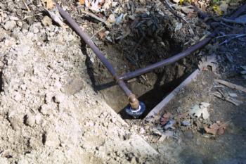 Drip tubing attached to retrofit sprinkler head, which replaced the original pop-up head<br>(click to enlarge)