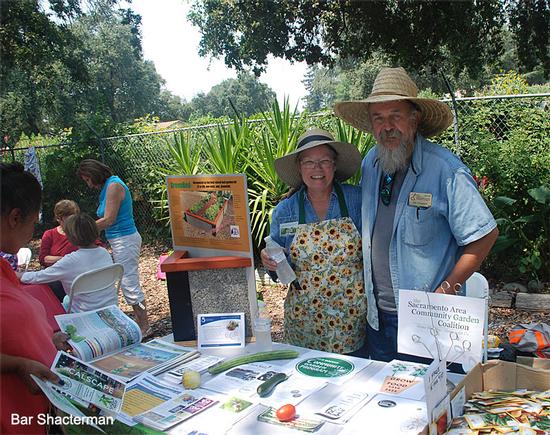 The Community Gardens table with Bill Maynard and Christy Wallace.<br>(click to enlarge)