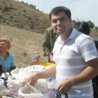 Bahodir with vendors of Kurut (dried yogurt balls) in Uzbekistan.