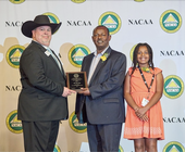 Oli Bachie, center, accepts the California Distinguished Service award as his daughter Marti Oli Gurmu looks on.