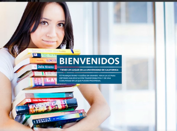 A dark-haired woman holds a stack of textbooks. Bienvenidos