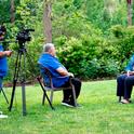 Miguel Sanchez, left, and Ricardo Vela, center, interview Lynn Schmitt-McQuitty on camera.