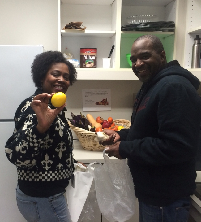 Cheryl Hyland and RayWilliams help themselves to fresh produce from the farmers market.