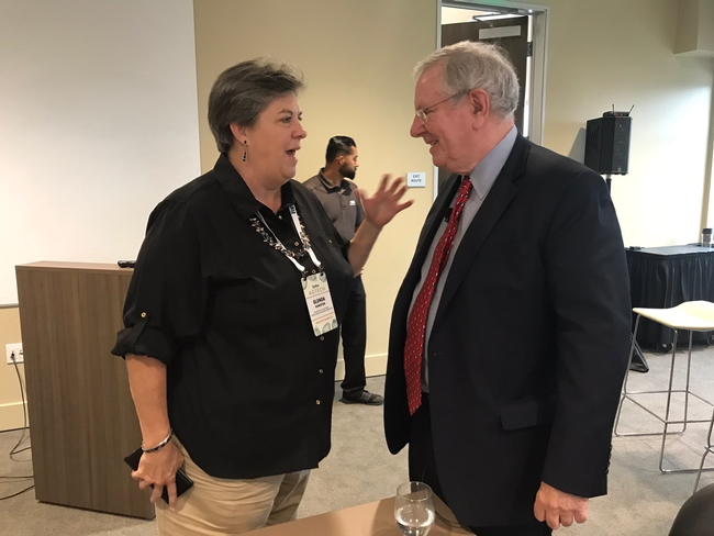 Humiston, left, talks with Steve Forbes at a breakfast at the Forbes AgTech Summit.