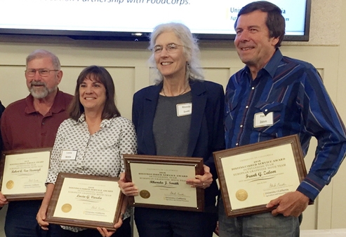 From left, Bob Van Steenwyk, Lucia Varela, Rhonda Smith and Frank Zalom of the European Grapevine Moth team show in 2016 accepting a UC ANR Distinguished Service Team Award.