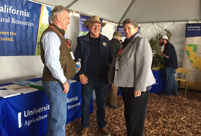 UCCE advisor Dan Munk, left, greets West Side farmer Joe Del Bosque and VP Glenda Humiston.
