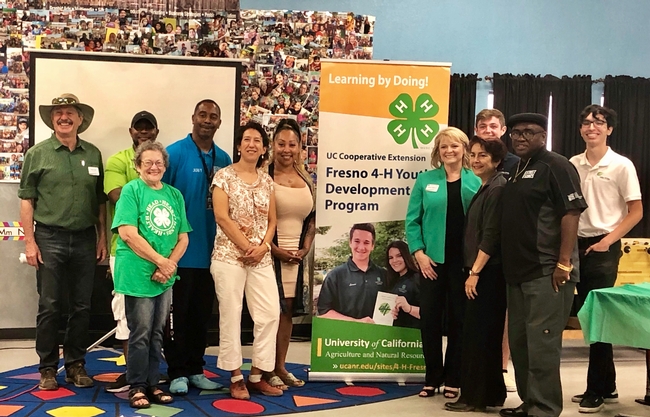 4-H community educator Alena Pacheco (in green jacket), introduced Regent Estolano (in white pants) and Sen. Caballero (next to Pacheco) to UCCE Fresno partners Street Saints, who offer a safe place for youth after school where they can develop employment skills through 4-H activities.