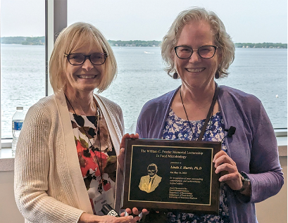 Linda Harris, right, received the William C. Frazier Memorial Lectureship Award from Kathleen Glass, Food Research Institute associate director.