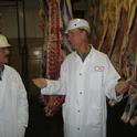 UCCE farm advisor Dan Drake (right) and processing plant personnel examine carcasses of UC steers.