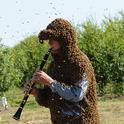 Norm Gary plays the B-flat clarinet while covered head to toe with bees. Photo by Kathy Keatley Garvey