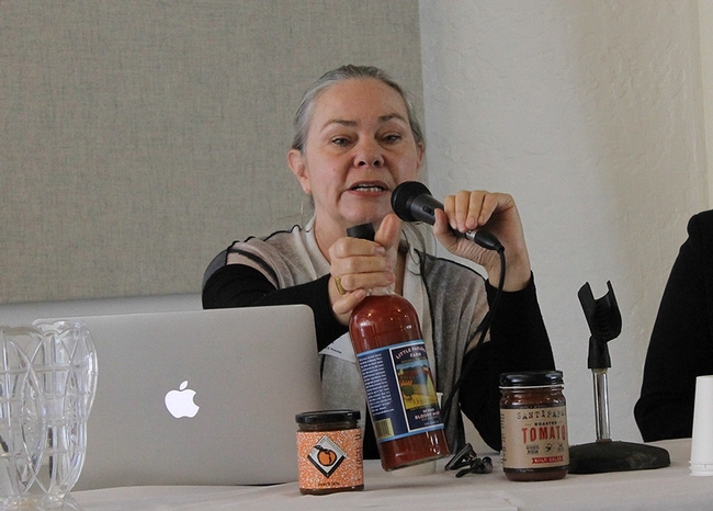 Merrilee Olson shows products made from a grower's tomatoes.
