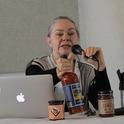 Merrilee Olson shows products made from growers' excess peaches and tomatoes.