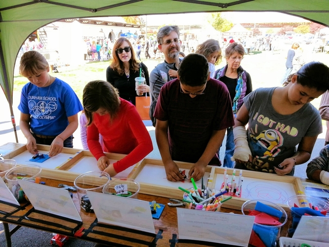 Youth experiment at a 4-H Junk Drawer Robotics booth at Bay Area Science Festival Discovery Day. (Photo: Sonoma County 4-H)