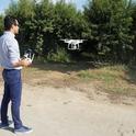 UC Cooperative Extension specialist Ali Pourreza flies a drone in an orchard. High-speed broadband at Kearney Research and Extension Center will make it easier for researchers to collect and share data.