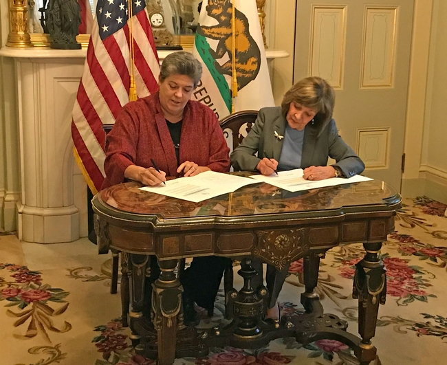 UC ANR vice president Glenda Humiston (left), and California Secretary of Agriculture Karen Ross sign a memorandum of understanding to initiate the new partnership to advance climate-smart agriculture.