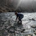 Tracy Schohr samples water in a stream in Butte County below the town of Paradise. Photo by Ryan Schohr