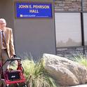 John Pehrson poses outside UC Lindcove Research and Extension Center's John E. Pehrson Hall, dedicated in his honor.