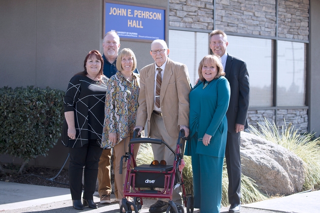 John E. Pehrson, center, poses with his proud children. From left, Linda Pehrson, David Pehrson, Karen Grace, Julie Pehrson and John R. Pehrson outside the building named for him.