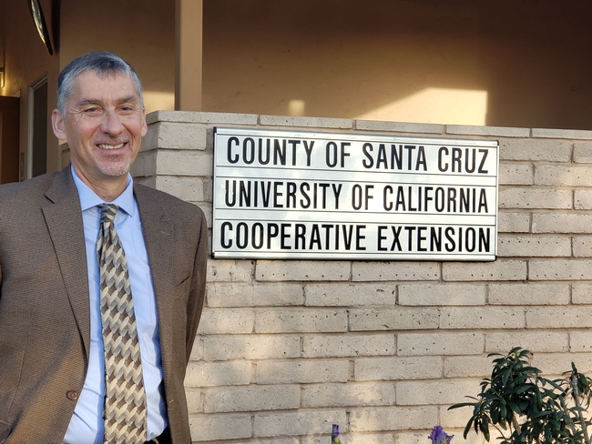 David Gonzalves poses by UC Cooperative Extension sign