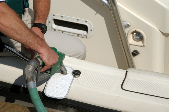 Catch drips with an absorbent “fuel bib” when you fuel your boat. Photo courtesy of BOAT US Foundation.