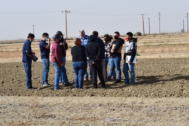 Photo 1.	Fresno State University agronomy students tour the 22-year conservation agriculture systems comparison field at the UC West Side Research and Extension Center in Five Points, CA on October 11, 2021.  The group was hosted by Dan Munk, Joy Hollingsworth, and Jeff Mitchell.
