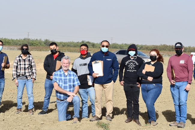 Photo 2.	Students in Dr. Ranjiy Riar’s agronomy class at Fresno State visiting UC Advisors Dan Munk and Joy Hollingsworth at the long-term conservation agriculture research field in Five Points, CA, October 11, 2021