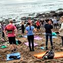 Group yoga on the beach