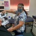 Health care worker at the Indian Health Center of Santa Clara County using their face shield