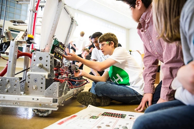 Young people work on a robot