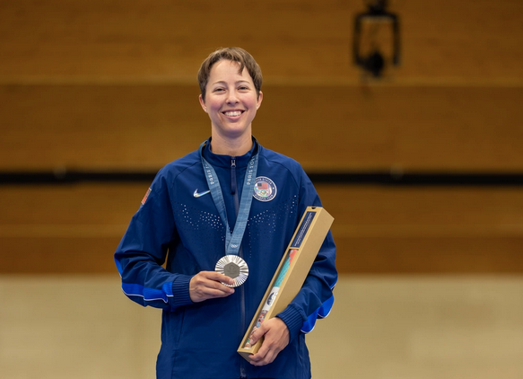 Sagen Maddalena holds the silver medal between her fingers as it hangs around her neck in Paris.